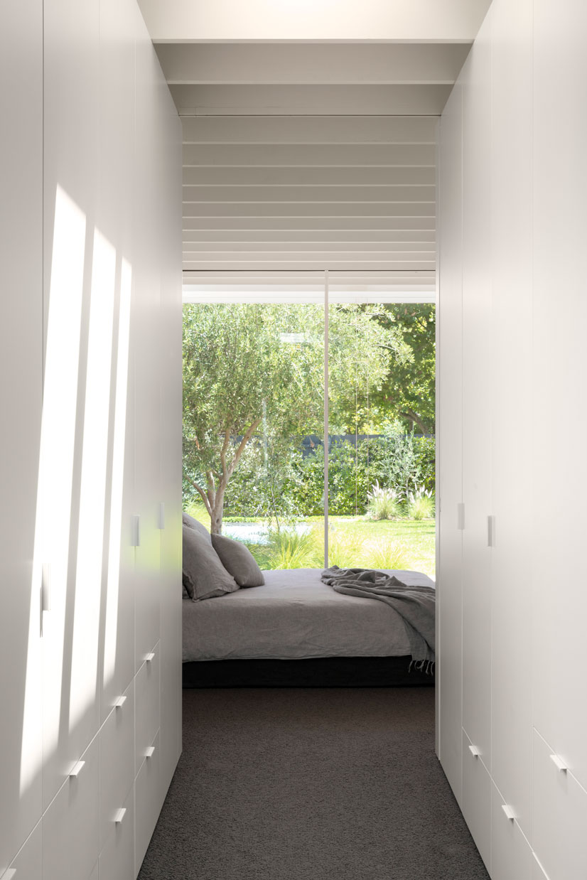 Melbourne Architects. View from the walk-in robe through the master bedroom and the garden beyond. Soft textures and ceiling rhythms create beautifully tactile spaces, extending outside to welcome the outdoors in.