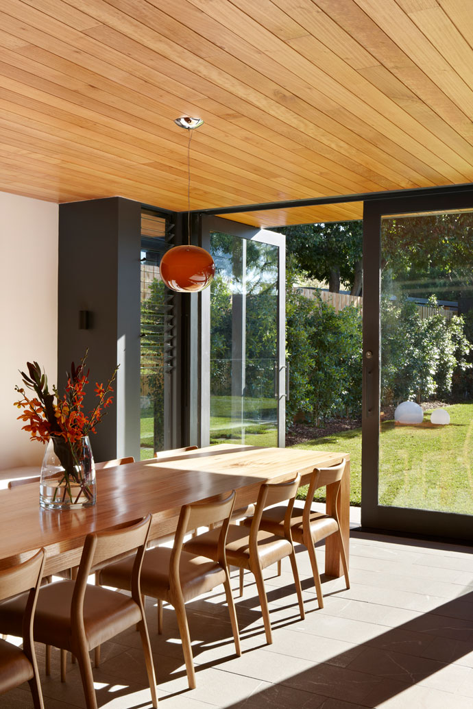 Local Architects. Communal dining table at Hawthorn House extends to the double doors opening up to north-facing garden.