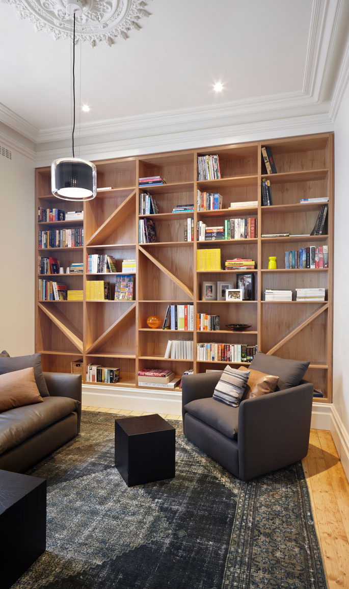 Hawthorn House Sitting Room in Heritage Section. Timber built-in shelves references the timber truss on the facade and creates a background.