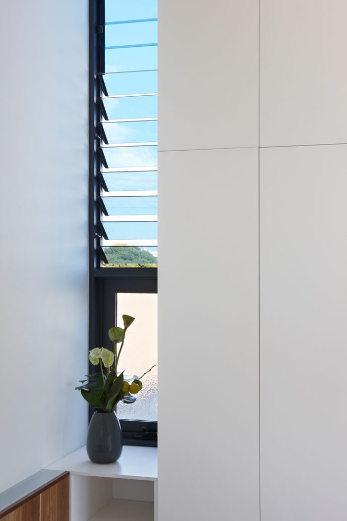 Glazed louvre window and joinery details in the master bedroom. 