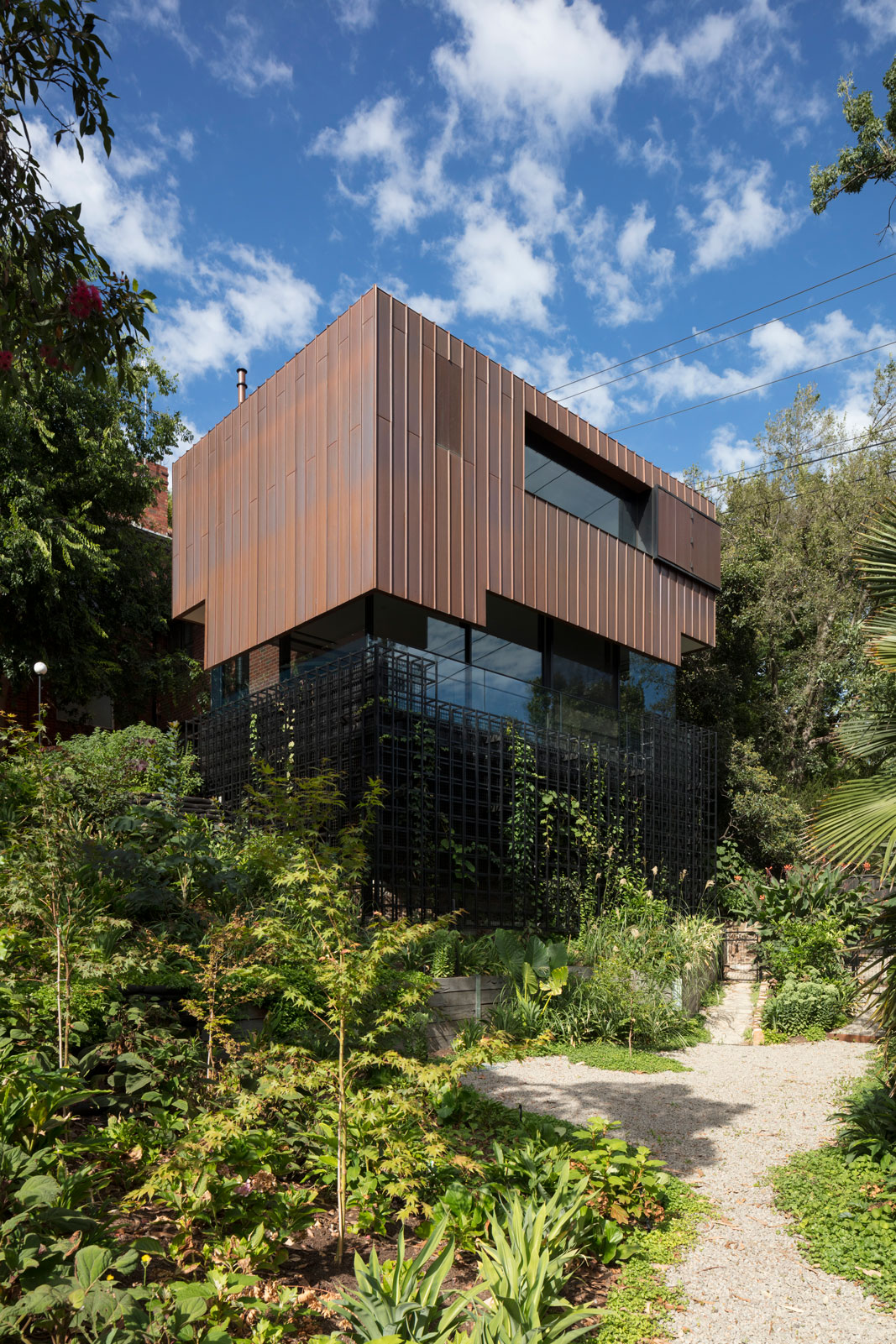 Residential Architecture. Copper Clad house rising above landscape