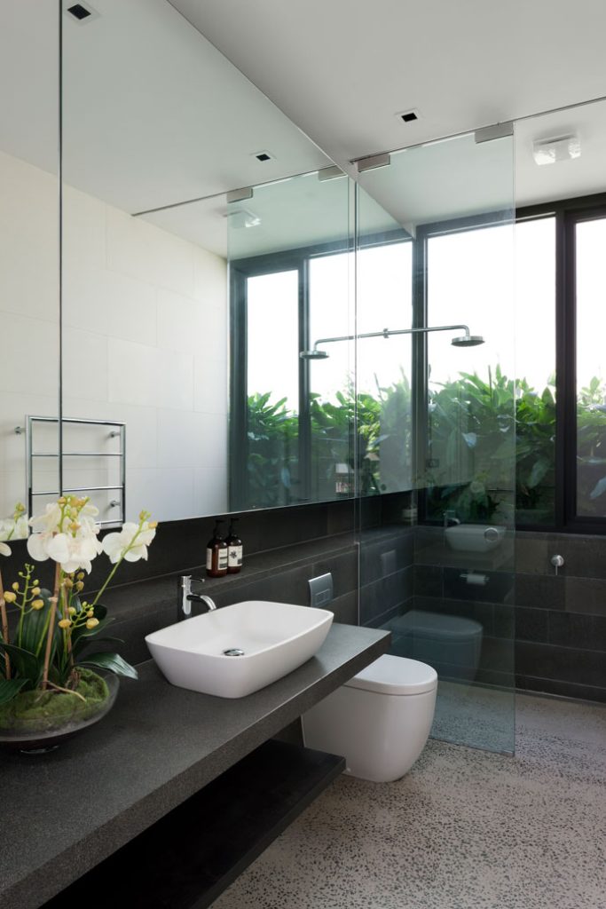 Toorak House Bathroom. Continuous blue stone mass creates a shelf for the bathroom stretching from vanity to the shower.